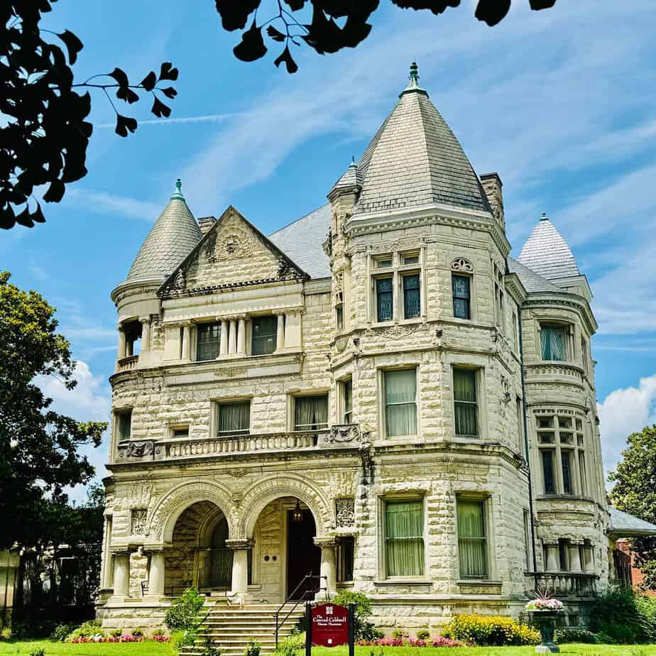 Old Louisville walking tours group walking past the Conrad-Caldwell House Museum