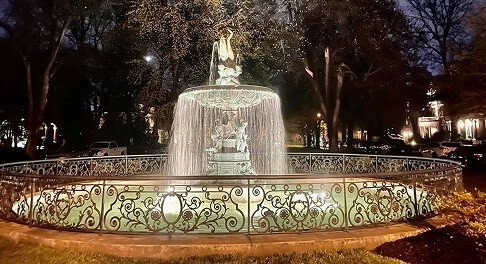 St. James Court fountain illuminated at night in Old Louisville