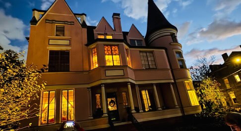 The Pink Palace mansion at night on St. James Court in Old Louisville