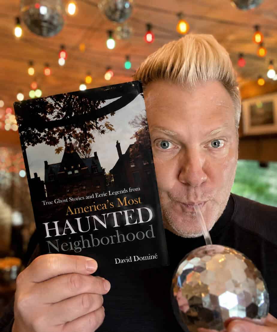 David Dominé holding his book America's Most Haunted Neighborhood, the true ghost stories behind Louisville Historic Tours' ghost walks