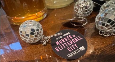 Glitter ball keychain souvenirs from the Louisville true crime walking tour